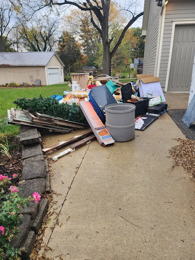 Dumpster being loaded with debris for Roofing Dumpster Rental in Brooklyn Park